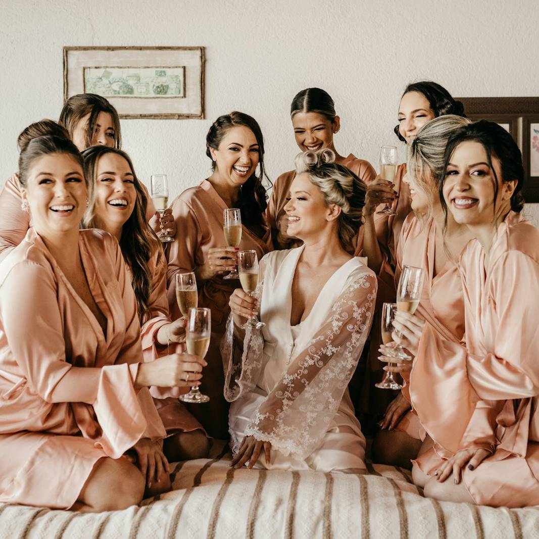 a group of women sitting on top of a bed